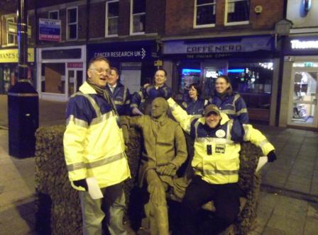 Street Angels gather at a statue