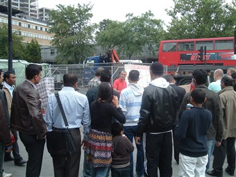 Crowds gather and listen to a street evangelist